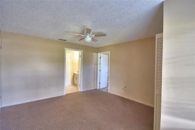 a view of a livingroom with a chandelier fan