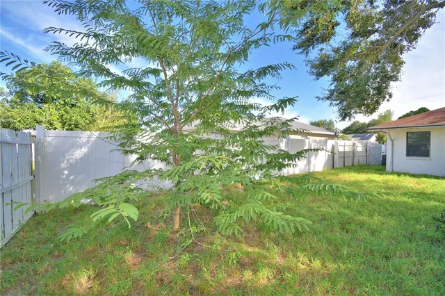 a backyard of a house with lots of green space