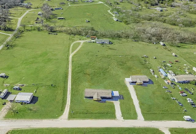 an aerial view of a residential houses with outdoor space