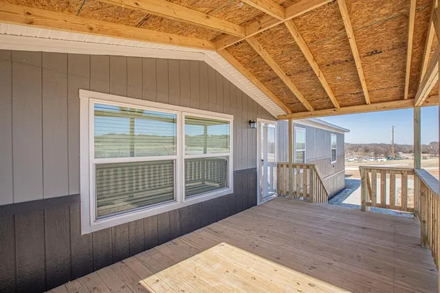 a view of a balcony with wooden floor
