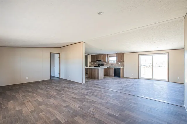 a view of a kitchen with wooden floor and windows