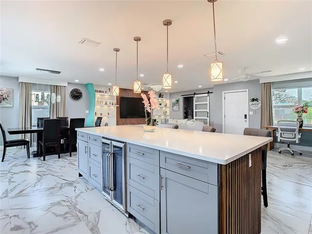 a kitchen with kitchen island a counter top space appliances and a center island