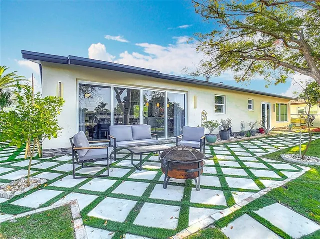 a view of a house with backyard porch and sitting area