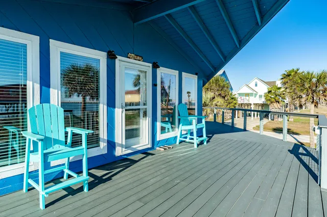 a house with wooden floor outdoor seating and yard