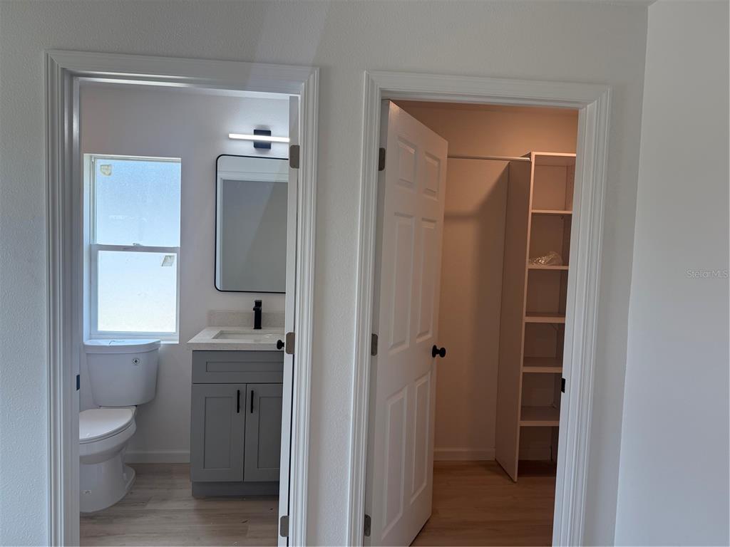 12847 Southwest 84th Terrace Road Ocala, FL 34473 - Photo 7 of 16 a bathroom with a toilet a sink and mirror