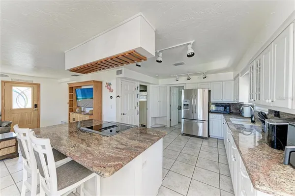 a kitchen with stainless steel appliances granite countertop a stove oven and a refrigerator