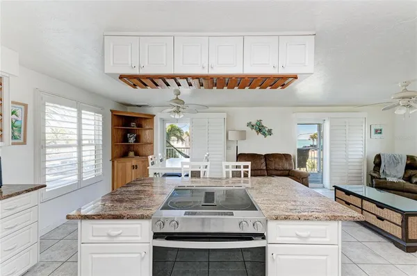 a kitchen with counter top space and windows