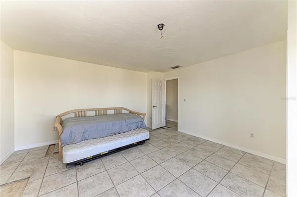 a living room with a bed furniture and next to a window