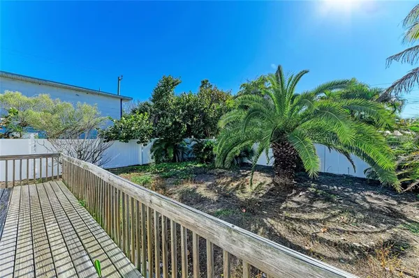 an aerial view of a house with a garden and lake view