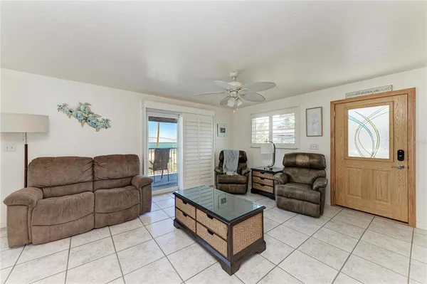 a living room with white cabinets and appliances