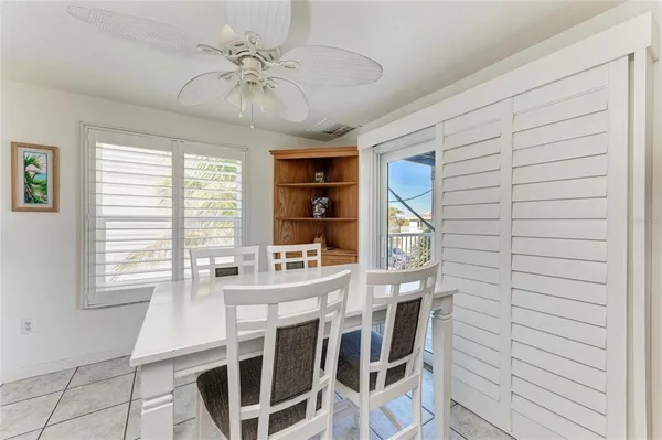 a view of a dining room with furniture and a chandelier fan
