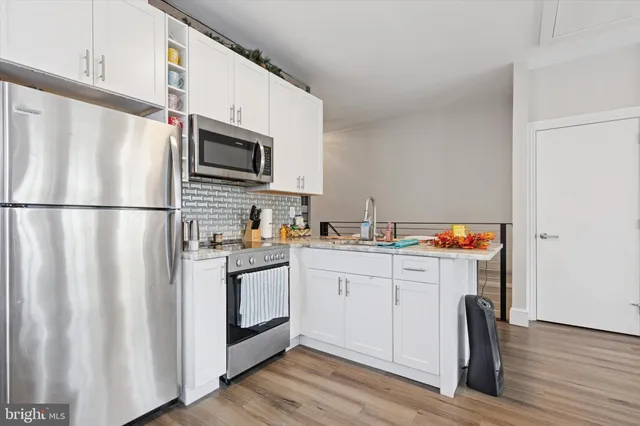 a view of kitchen with furniture and wooden floor