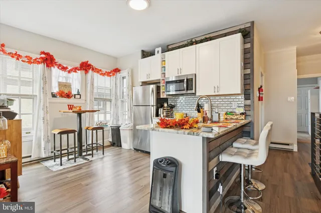 a living room with lots of furniture and a book shelf