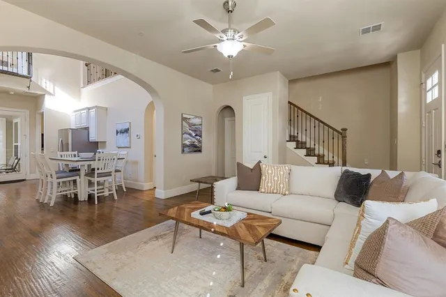 a living room with furniture kitchen view and a dining table
