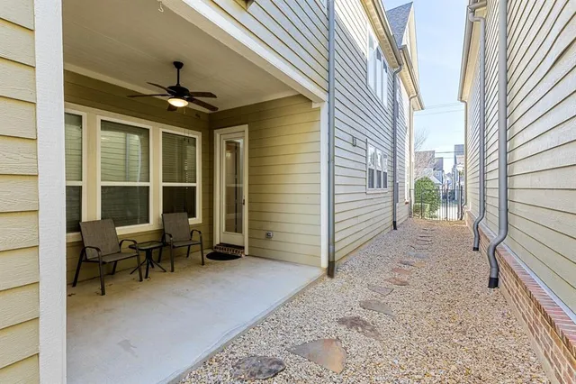 a view of a porch with furniture and a yard