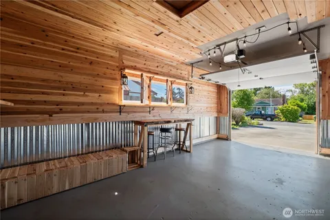 a view of a porch with furniture and a yard