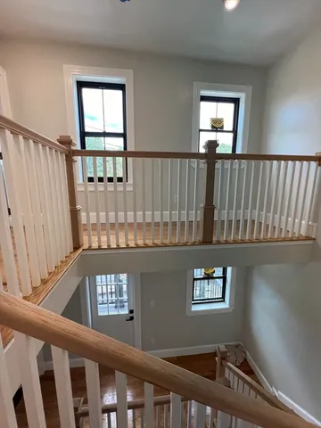 a view of entryway and hall with wooden floor