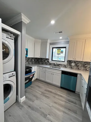a kitchen with granite countertop a stove top oven sink and cabinets