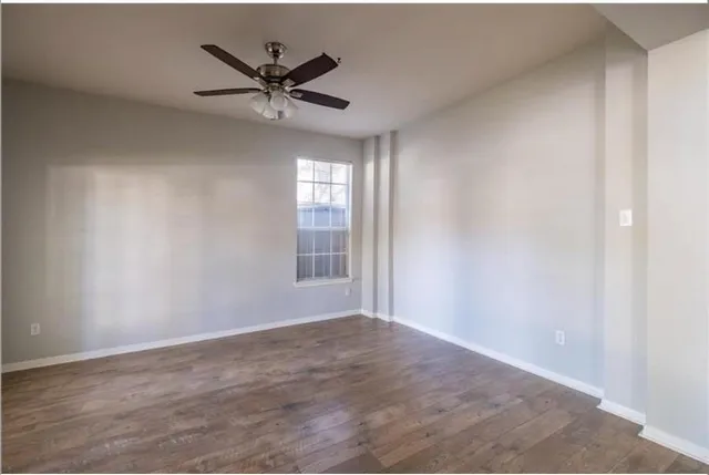 a view of a livingroom with a ceiling fan and window