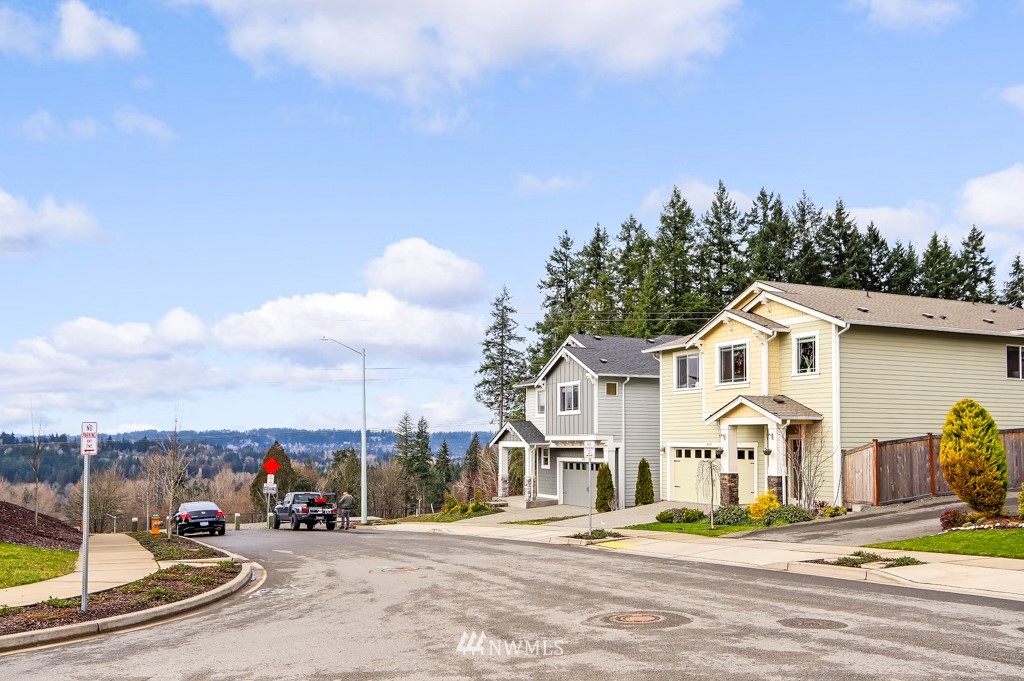 4311 235th Place Southeast Bothell, WA 98021 - Photo 27 of 32 a view of a white house with a big yard and potted plants