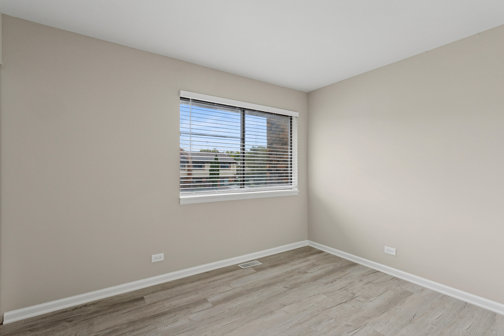 4 Tower Court Downers Grove, IL 60516 - Photo 16 of 20 a view of an empty room with wooden floor and a window