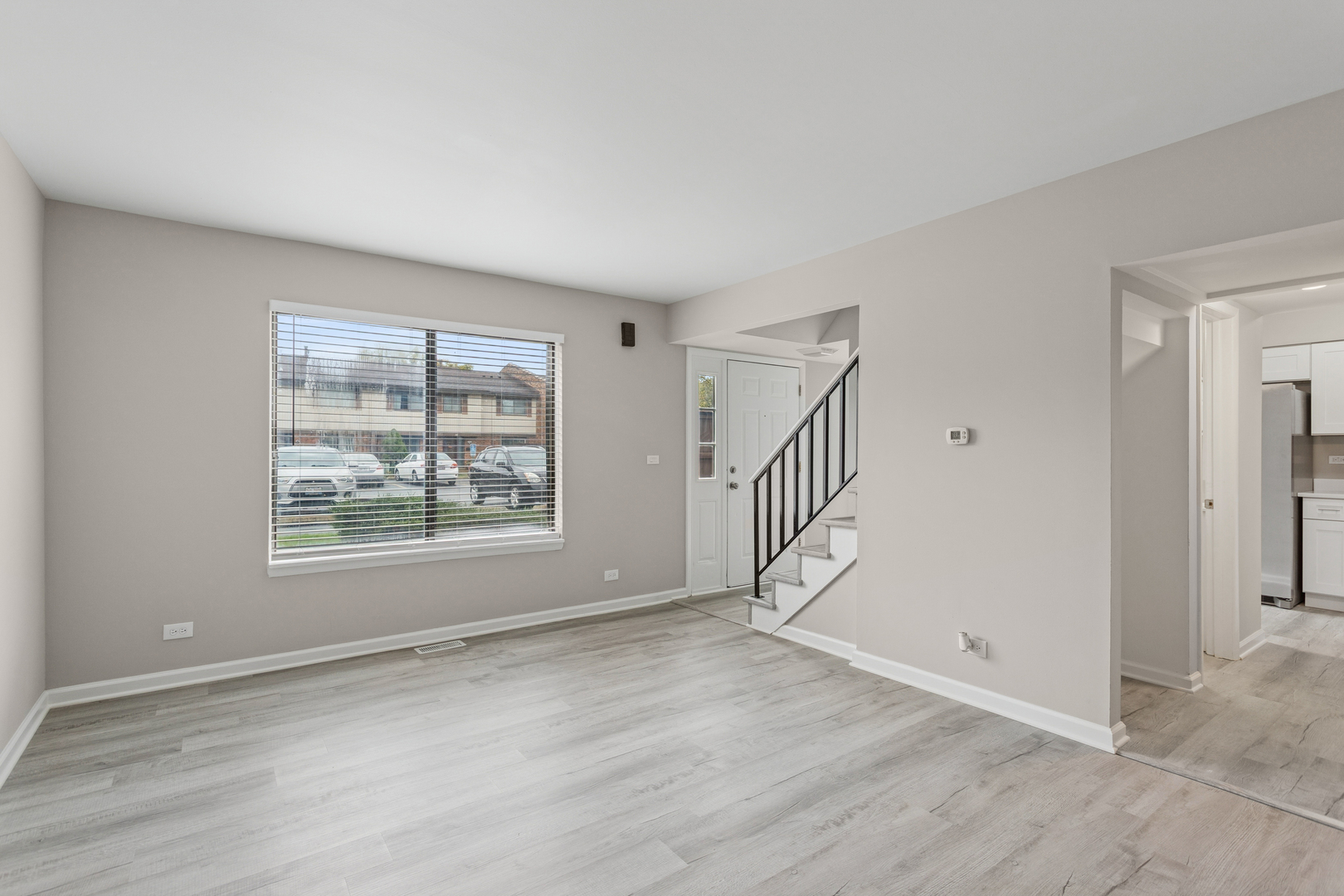 4 Tower Court Downers Grove, IL 60516 - Photo 3 of 20 a view of an empty room with wooden floor and a window
