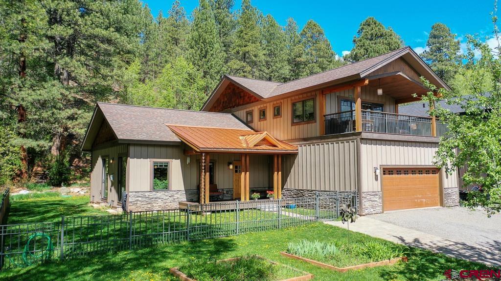 a front view of a house with a yard table and chairs