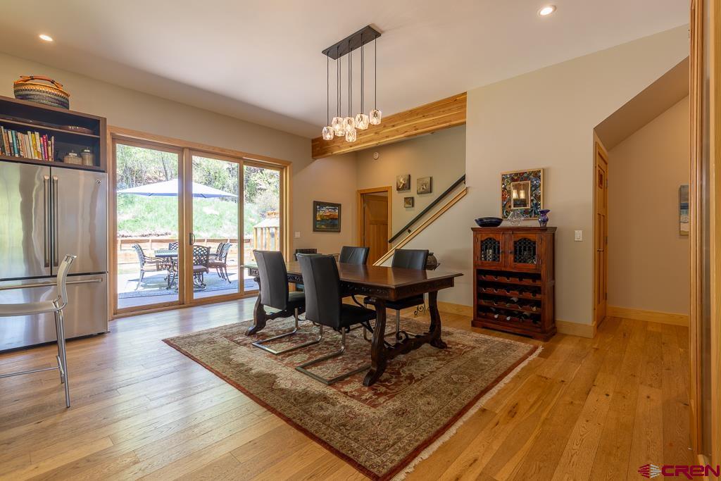 7041 County Road 203 Durango, CO 81301 - Photo 13 of 45 a living room with furniture a dining table and a floor to ceiling window