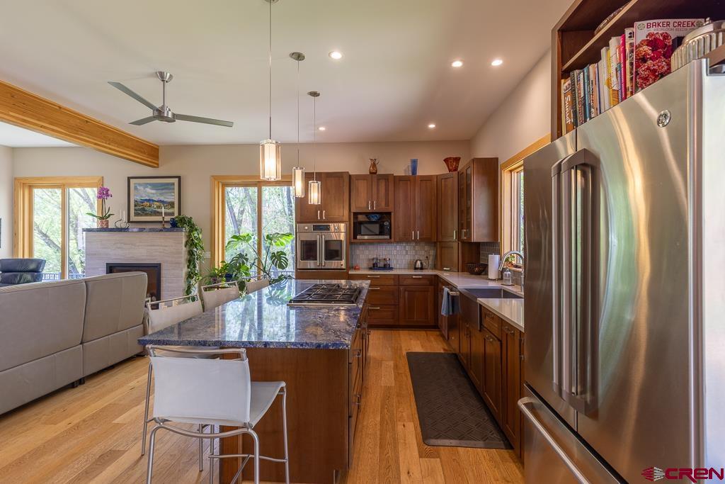 7041 County Road 203 Durango, CO 81301 - Photo 16 of 45 a kitchen with stainless steel appliances granite countertop sink refrigerator and microwave