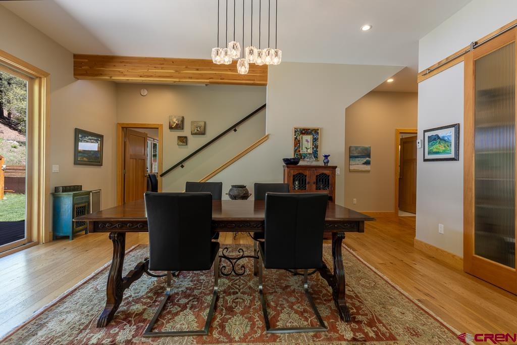 7041 County Road 203 Durango, CO 81301 - Photo 18 of 45 a view of a dining room with furniture window and wooden floor