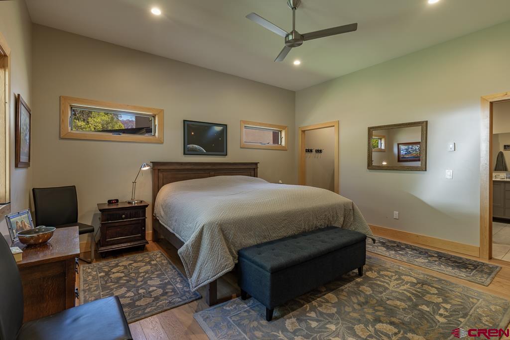 7041 County Road 203 Durango, CO 81301 - Photo 20 of 45 a spacious bedroom with a bed and a couch