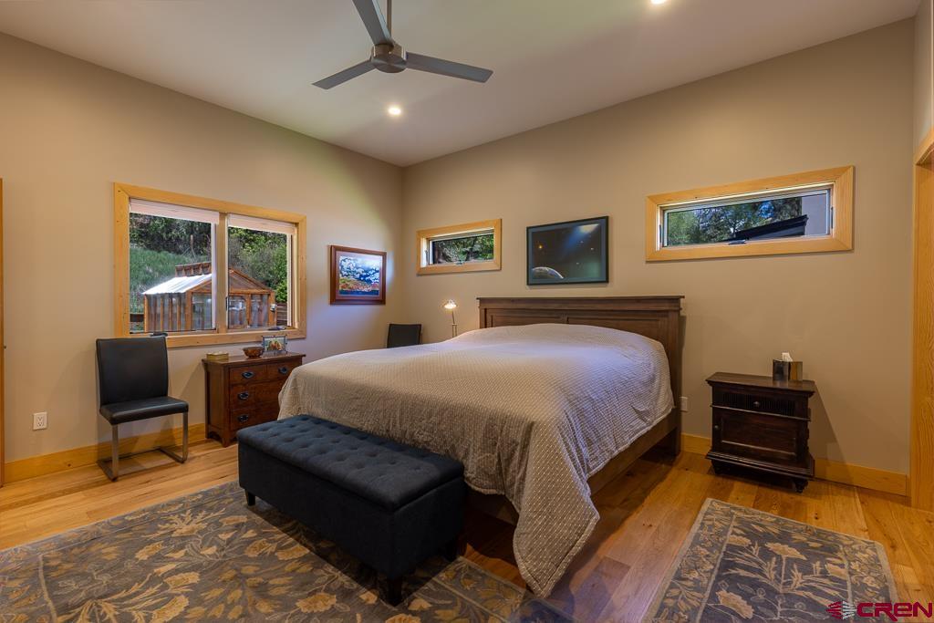 7041 County Road 203 Durango, CO 81301 - Photo 21 of 45 a spacious bedroom with a bed and a desk