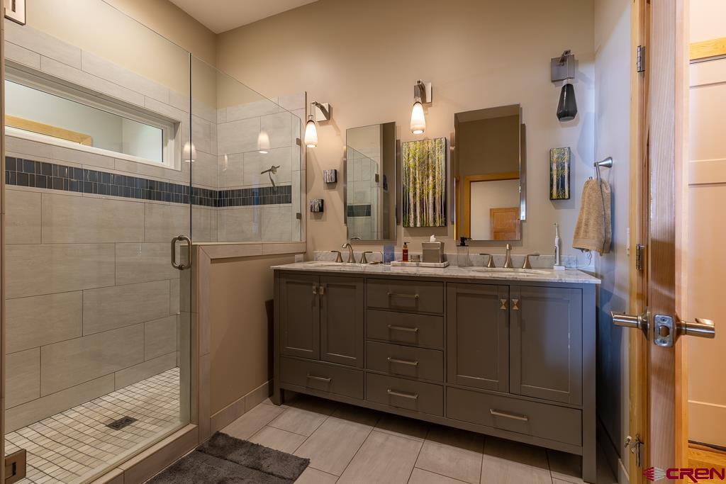 7041 County Road 203 Durango, CO 81301 - Photo 23 of 45 a bathroom with a double vanity sink and mirror