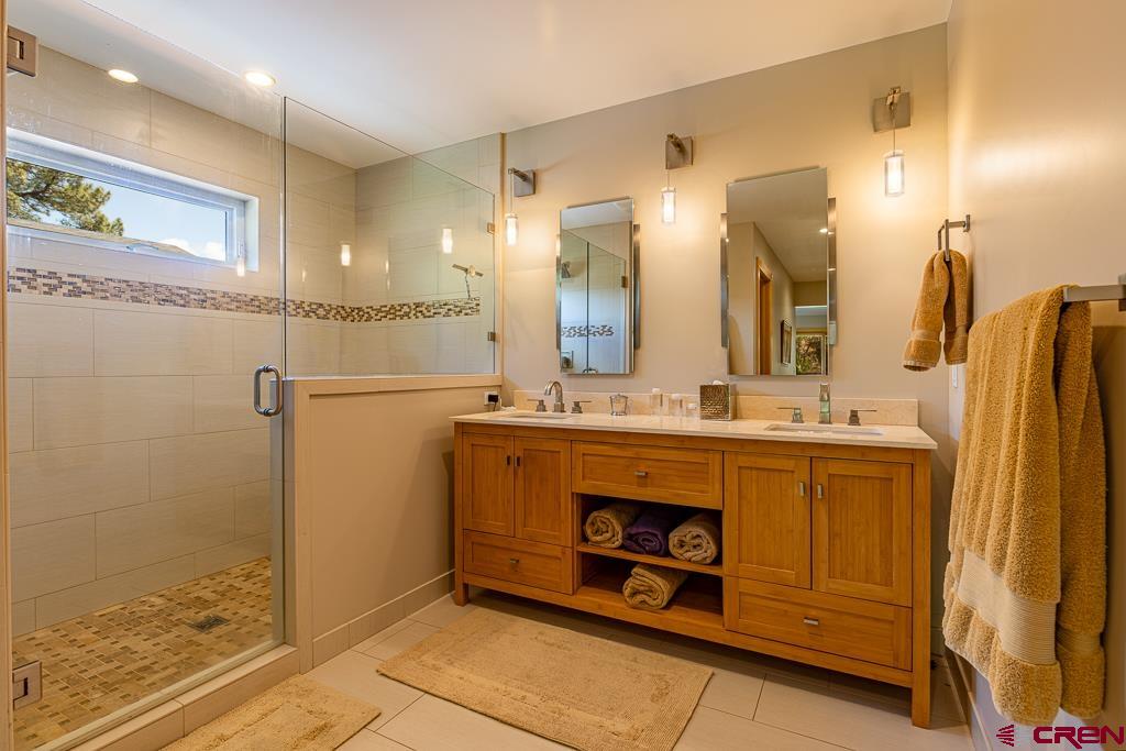 7041 County Road 203 Durango, CO 81301 - Photo 28 of 45 a bathroom with a sink mirror and vanity