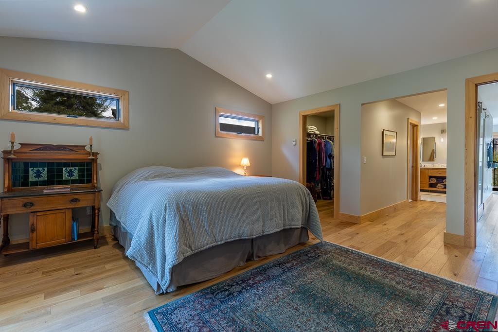 7041 County Road 203 Durango, CO 81301 - Photo 29 of 45 a spacious bedroom with a bed and a flat screen tv