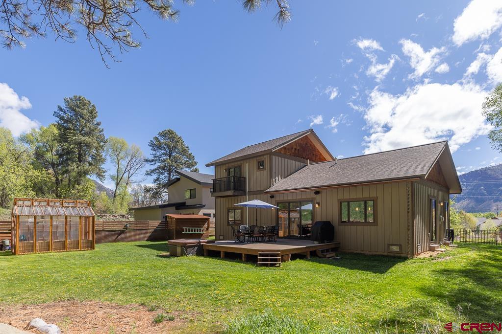 7041 County Road 203 Durango, CO 81301 - Photo 3 of 45 a front view of a house with a garden and deck