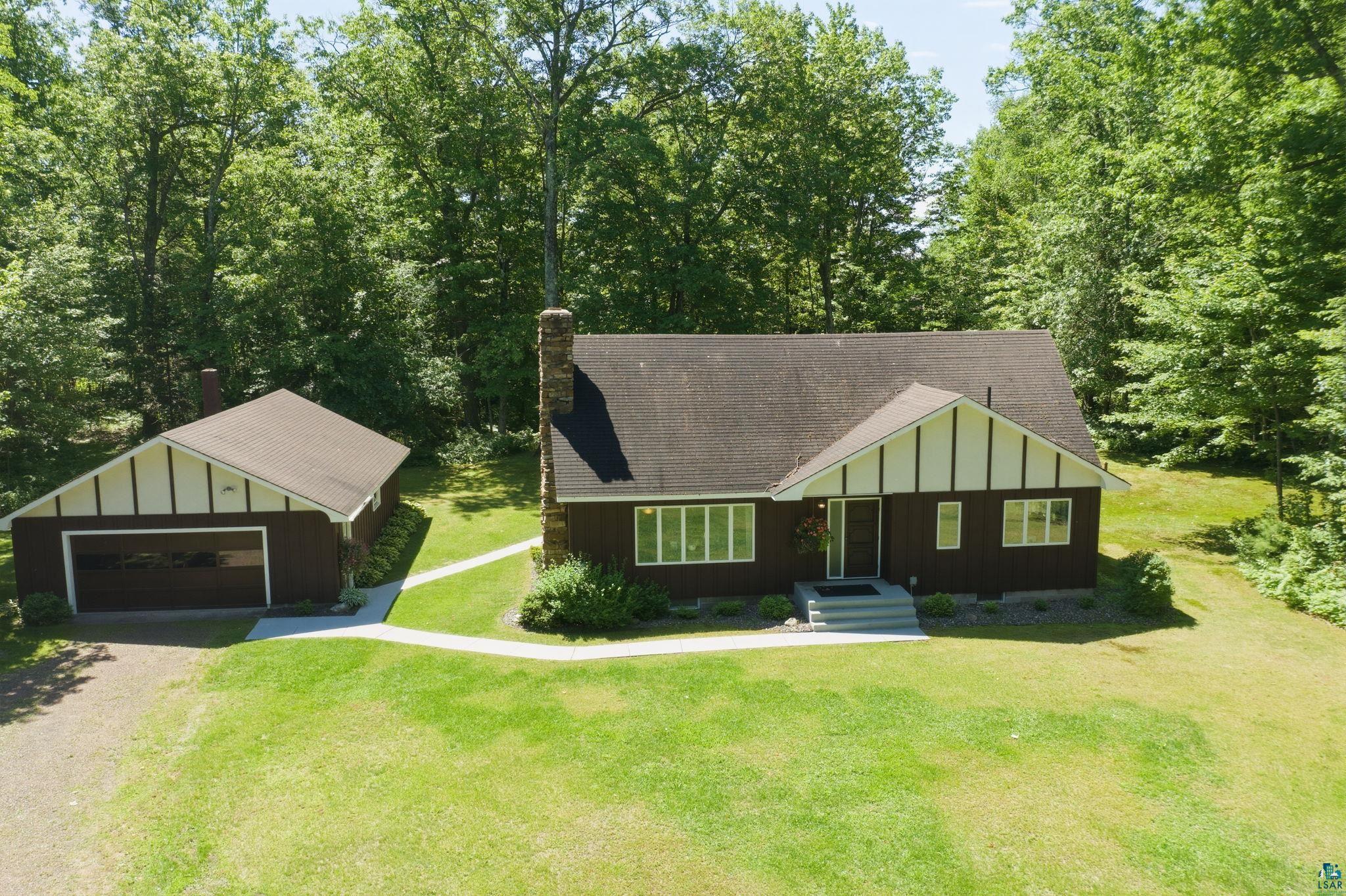 27485 South Kane Road Ashland, WI 54806 - Photo 28 of 35 Ranch-style residence featuring a dark brown exterior with white trim accents and a prominent stone chimney