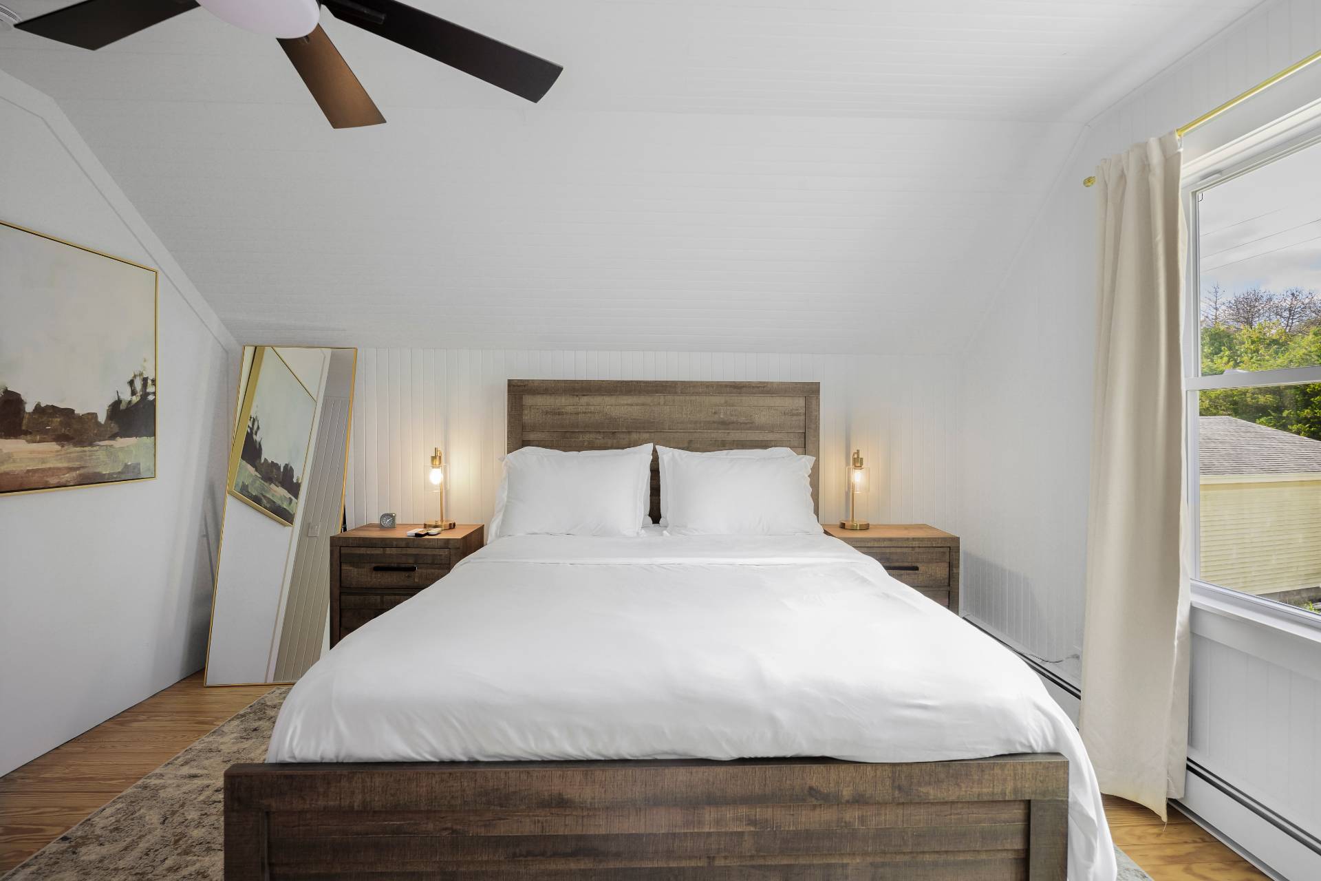 86 Old Country Road East Quogue, NY 11942 - Photo 12 of 16 a large bed sitting in a bedroom next to a window