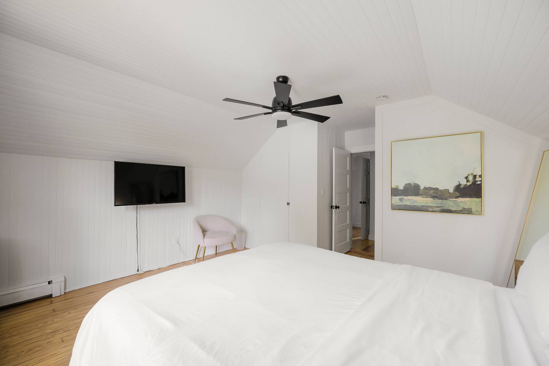 86 Old Country Road East Quogue, NY 11942 - Photo 14 of 16 a bedroom with a bed and a flat screen tv