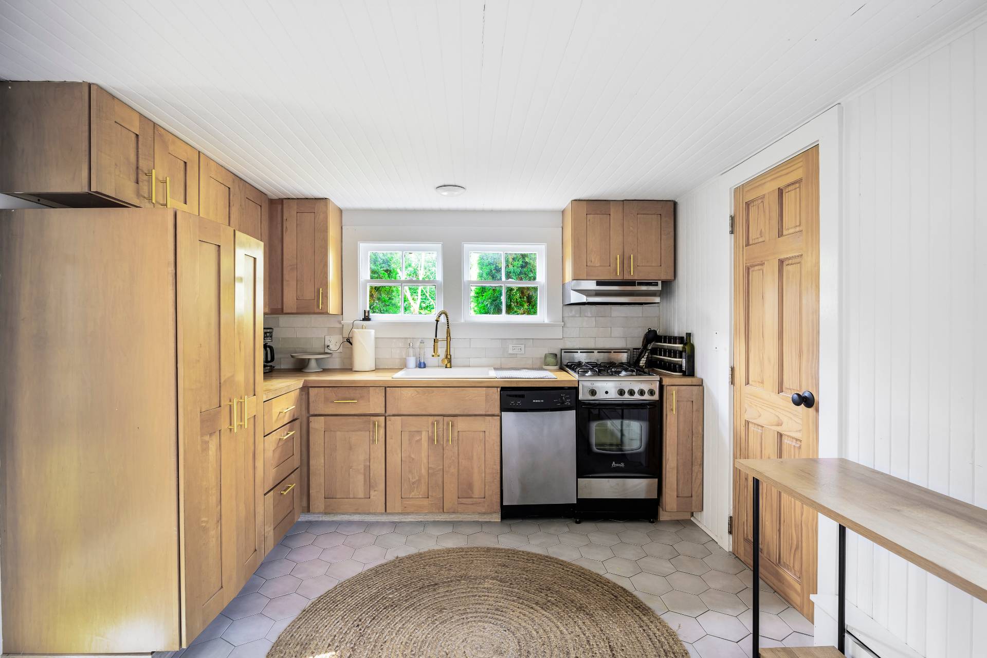 86 Old Country Road East Quogue, NY 11942 - Photo 2 of 16 a kitchen with stainless steel appliances granite countertop a refrigerator sink and stove