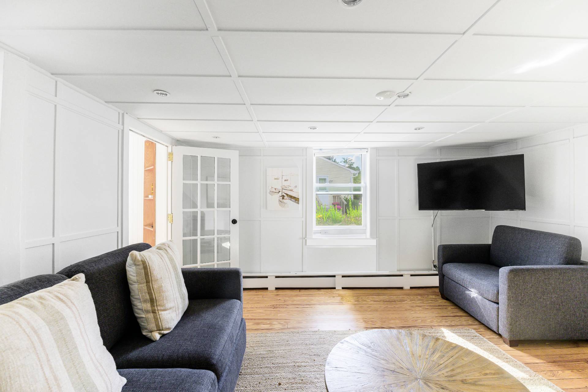 86 Old Country Road East Quogue, NY 11942 - Photo 8 of 16 a living room with furniture and a flat screen tv