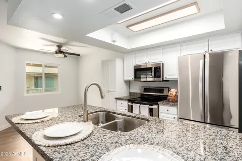 an empty room with a window and a ceiling fan