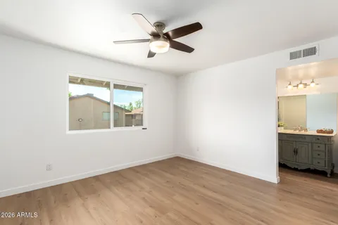 a bathroom with a sink vanity toilet and a mirror