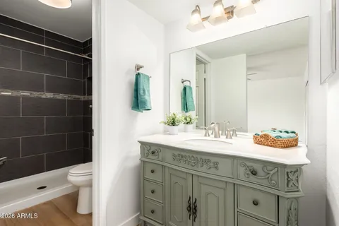 an empty room with a window and a ceiling fan