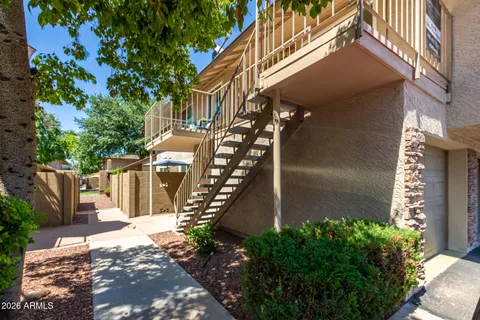 a view of a chairs and table in the balcony