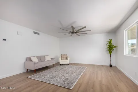 a living room with furniture and a wooden floor