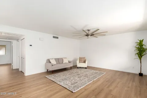 a living room with furniture and kitchen view