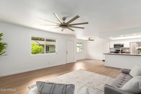 a kitchen with a granite countertop sink and natural light