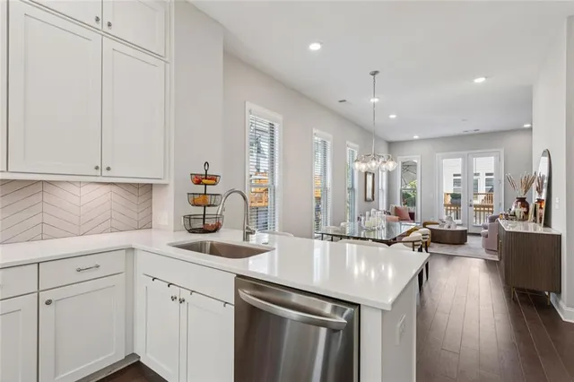 a kitchen with sink refrigerator and cabinets