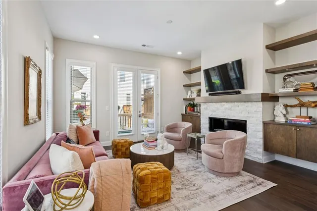 a living room with fireplace furniture and a flat screen tv